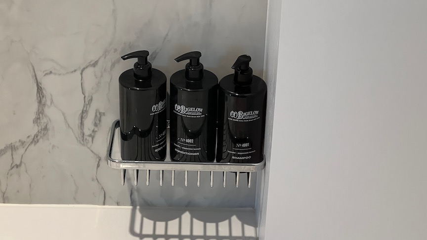 Three bottles of C.O. Bigelow products in the shower of a Retreat suite, provided in the retreat on celebrity cruises