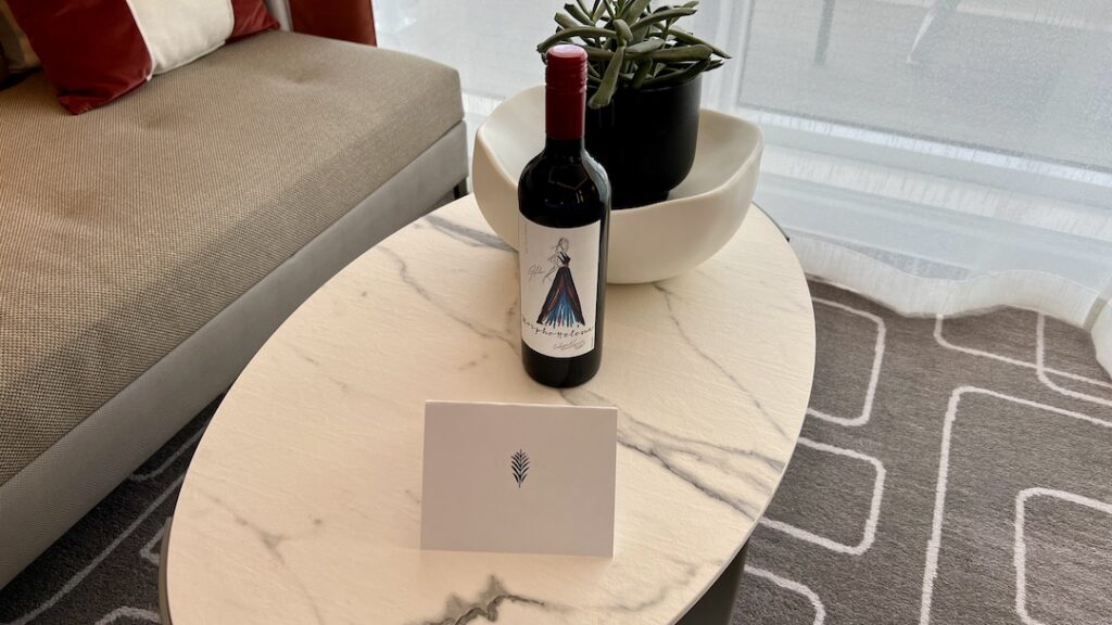 Welcoming touch in Celebrity Ascent Sky Suite with a complimentary bottle of wine, elegantly presented.